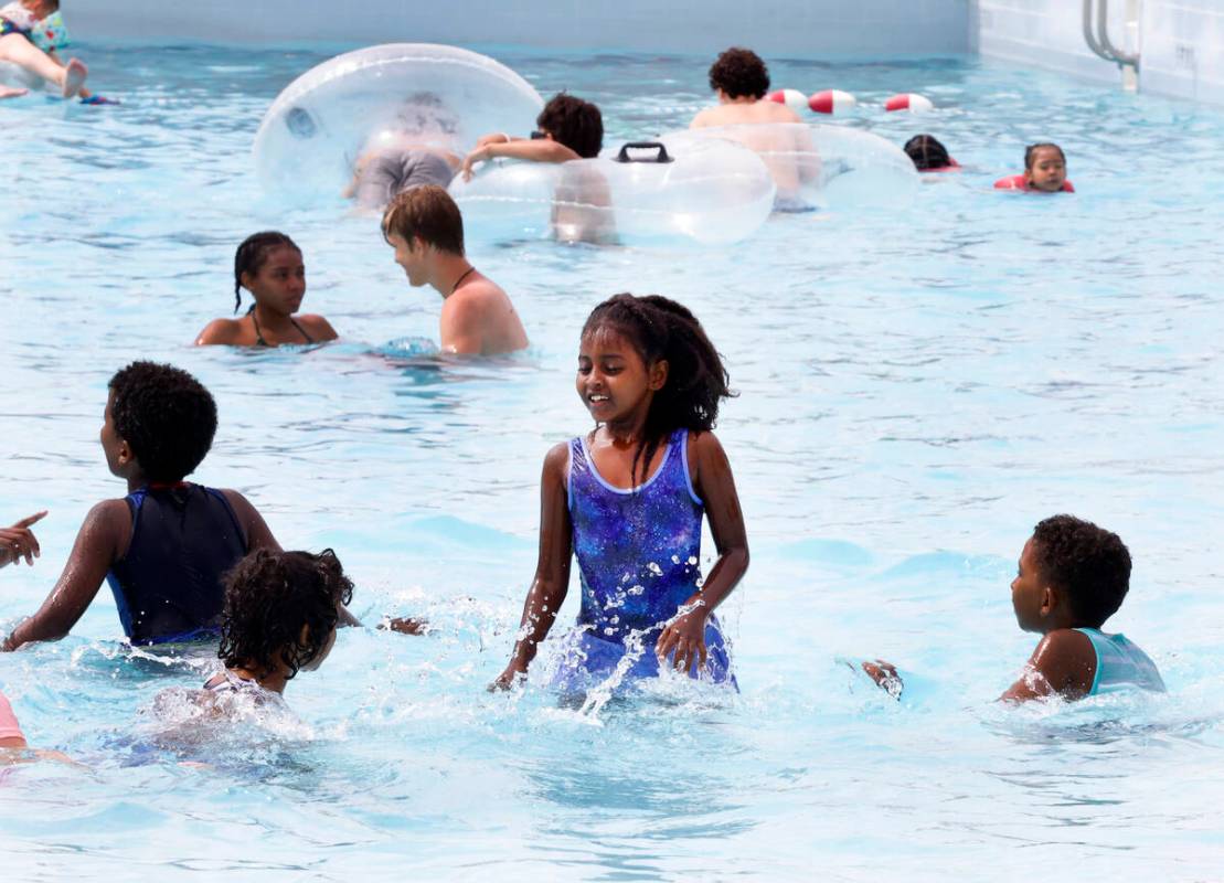 Parkgoers, including Delina Weldegebriel, 8, center, play on a hot day at Cadillac Shore Wave p ...