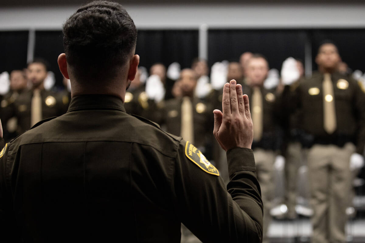 Graduates and current officers recite the Law Enforcement Code of Honor during the Las Vegas Me ...