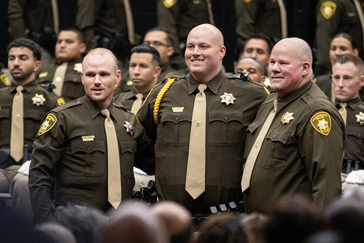 Distinguished recruit Caden Sink, center, takes photographs with his family members during the ...