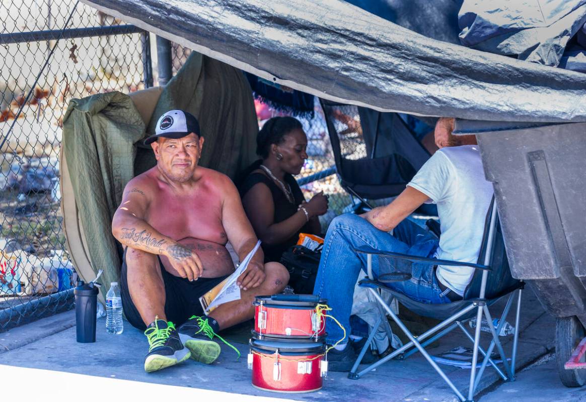 Some homeless escape the heat under a tarp shelter along North A Street as Vegas Stronger's Str ...