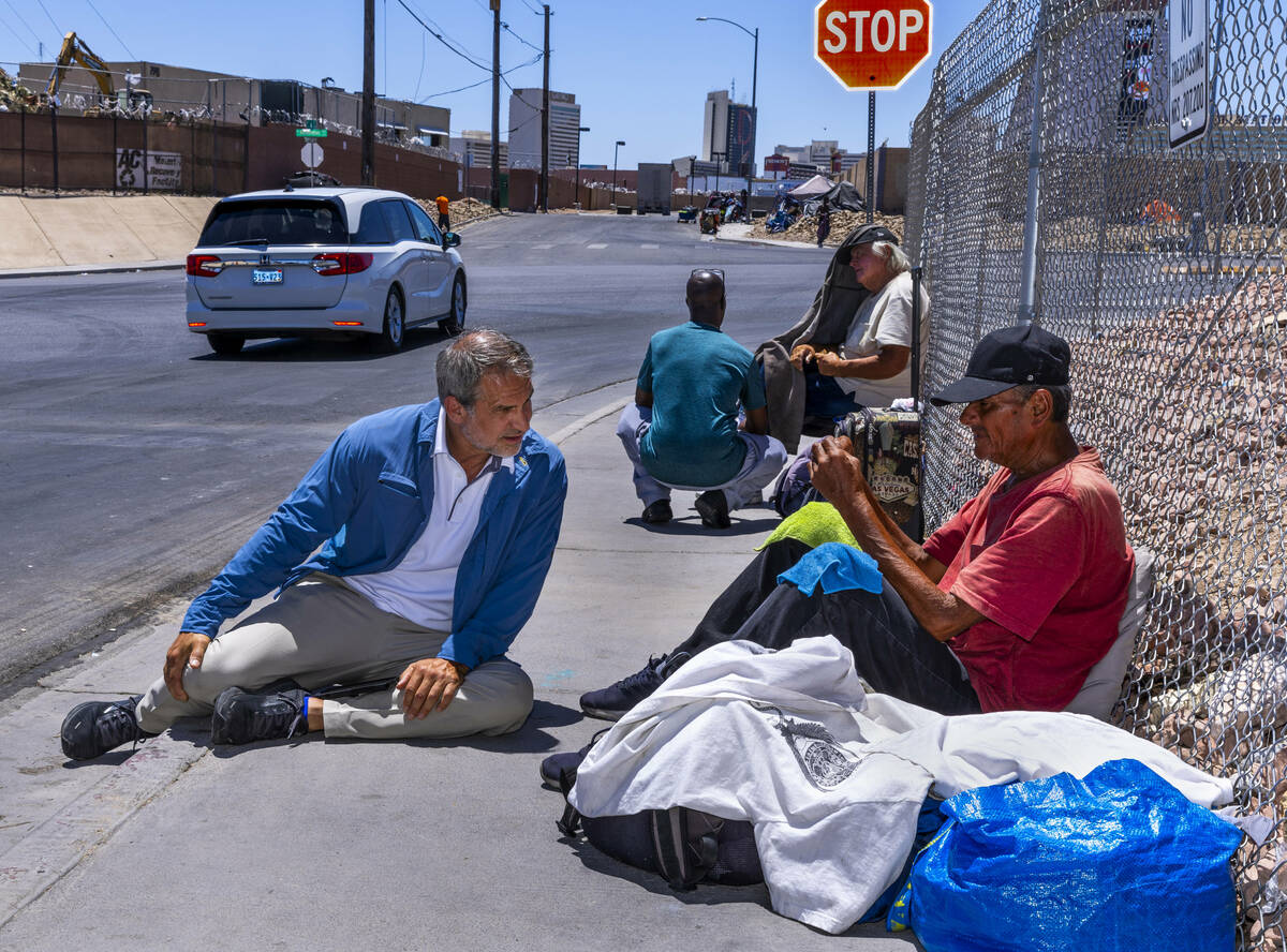 Vegas Stronger's president Dave Marlon talks with a homeless man about E. Washington Ave. as he ...