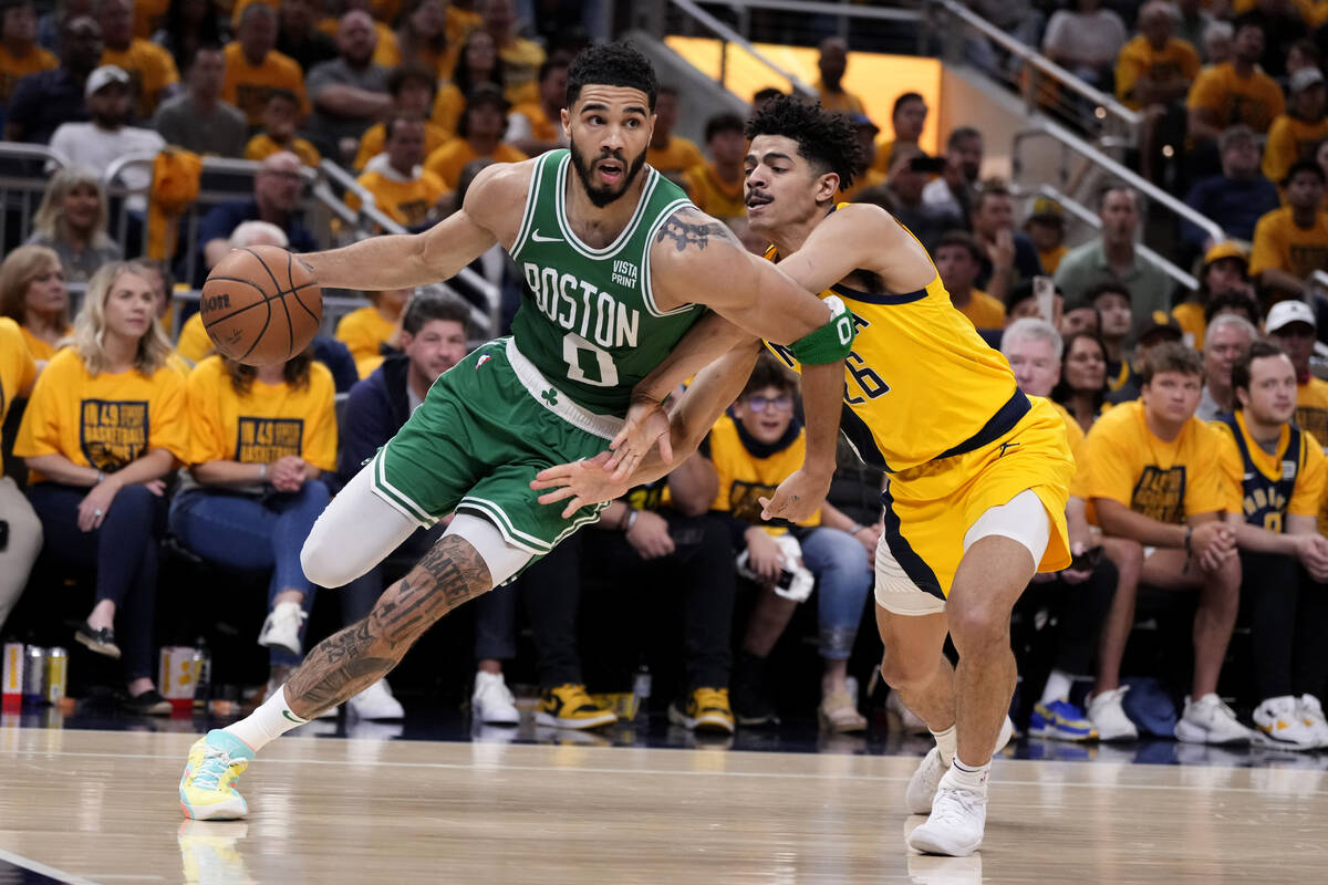 Boston Celtics forward Jayson Tatum (0) drives to the basket past Indiana Pacers guard Ben Shep ...