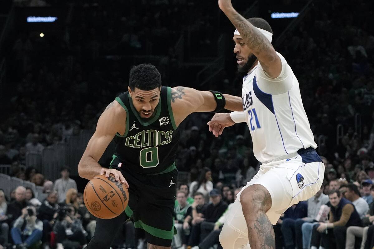 Boston Celtics' Jayson Tatum (0) drives past Dallas Mavericks' Daniel Gafford (21) during the f ...