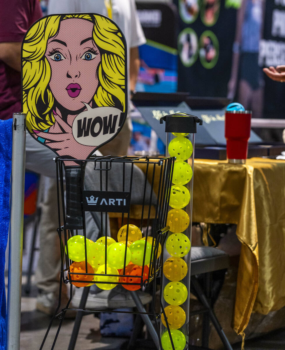 Arti sells artistically designed pickleball paddles during the World Pickleball Convention with ...