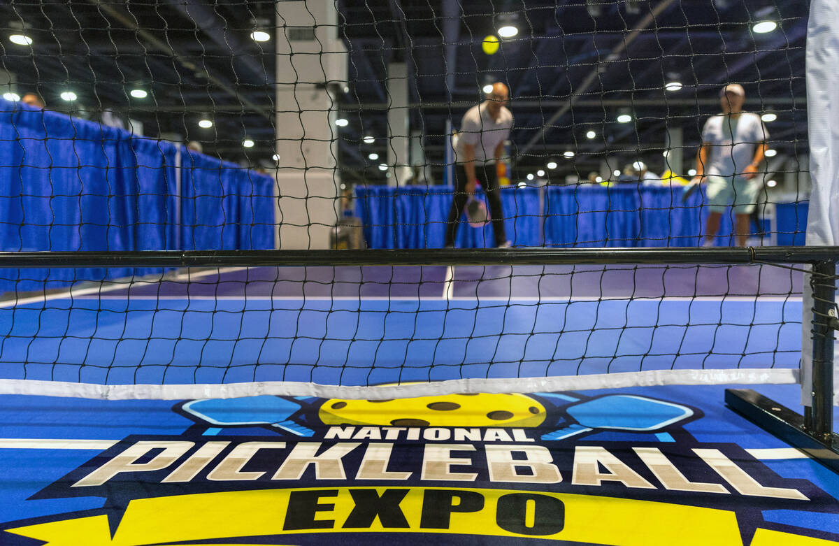 Attendees play a round of doubles on a practice court during the World Pickleball Convention wi ...