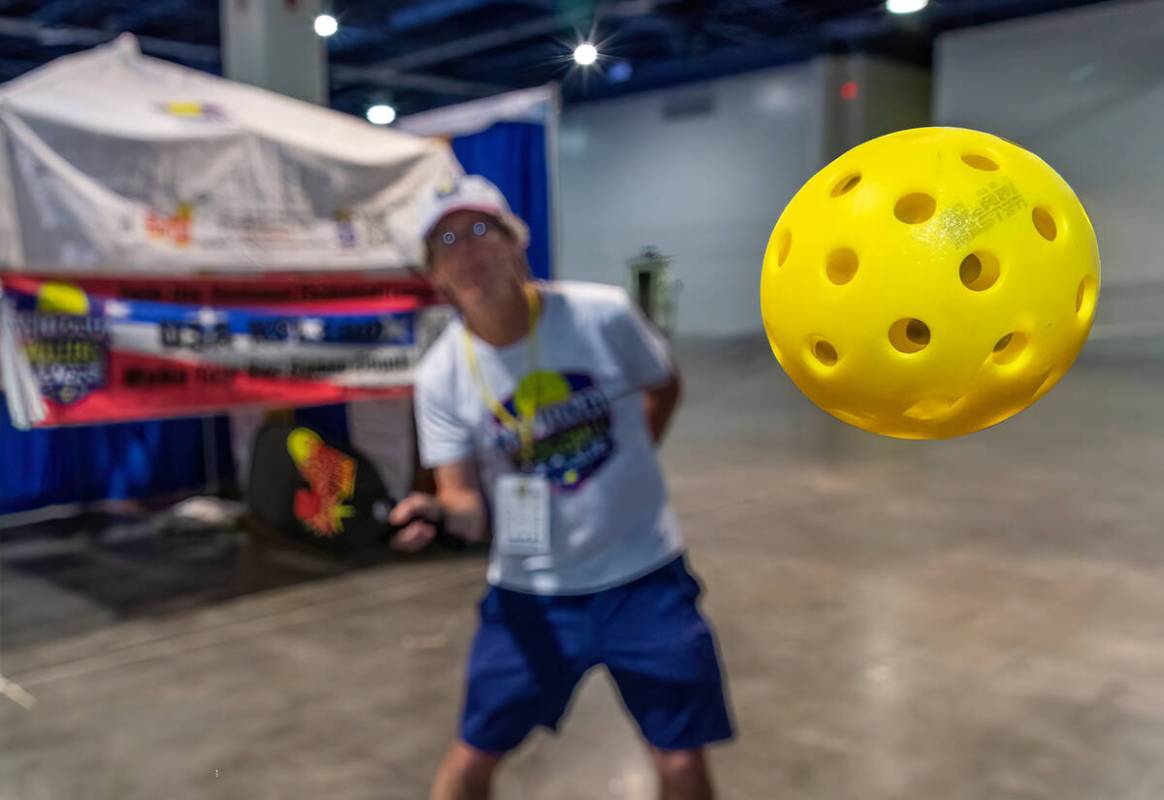 Gordon Gebert demonstrates his Slam Master Pro pickleball training paddle during the World Pick ...