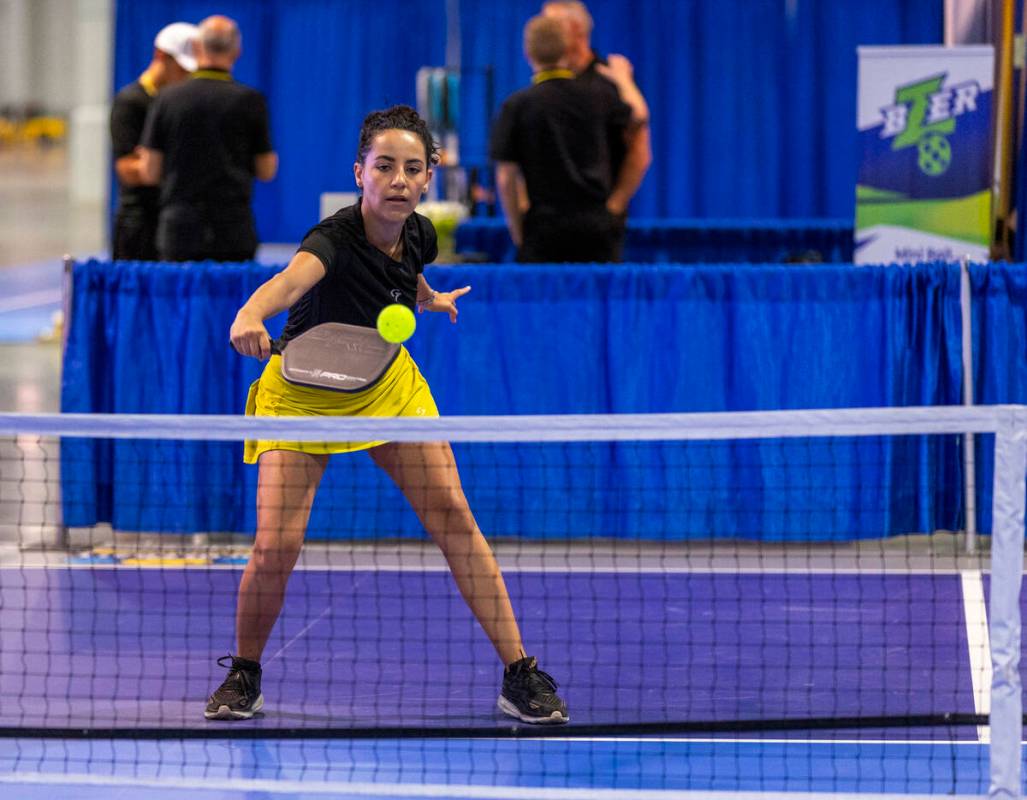 Daniela Filippini returns a serve while playing on one of the temporary courts used to try out ...