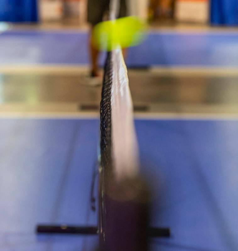 A ball clears a practice net during the World Pickleball Convention within the Las Vegas Conven ...