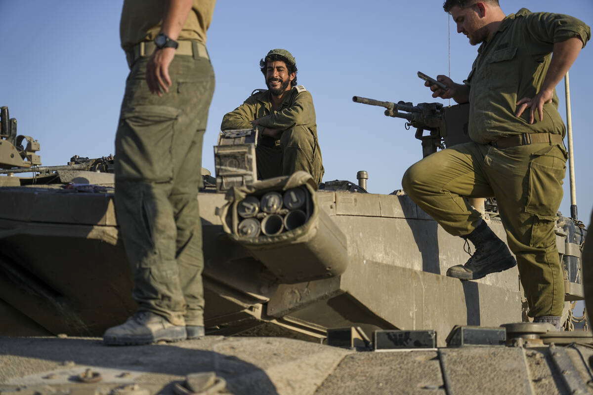 Israeli soldiers on their tank near the Israeli-Gaza border, in southern Israel, Wednesday, Jun ...