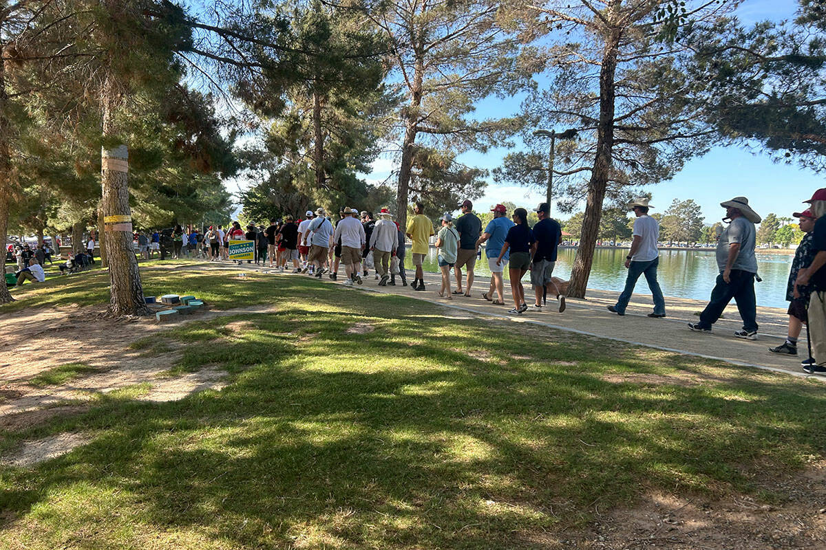 Trump supporters walk along a path to get in line for the former president’s rally at Sunset ...