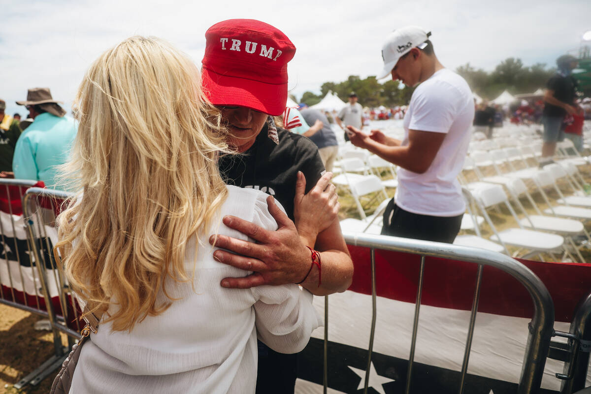 Fans of former President Donald Trump embrace after a rally at Sunset Park on Sunday, June 9, 2 ...