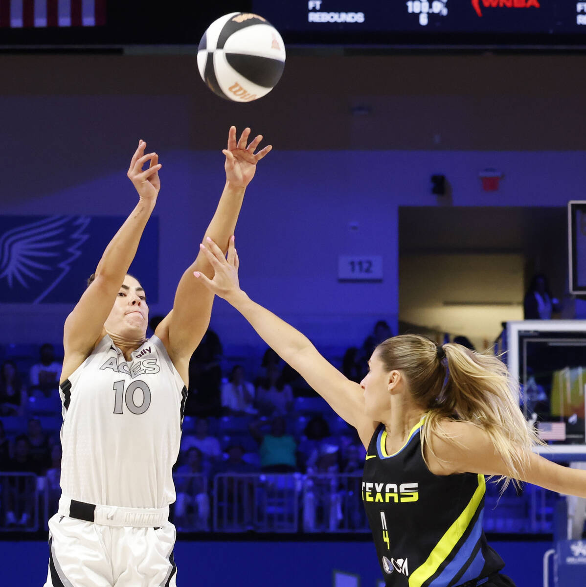 Las Vegas Aces guard Kelsey Plum (left) shoots a three-pointer over Dallas Wings guard Jacy She ...