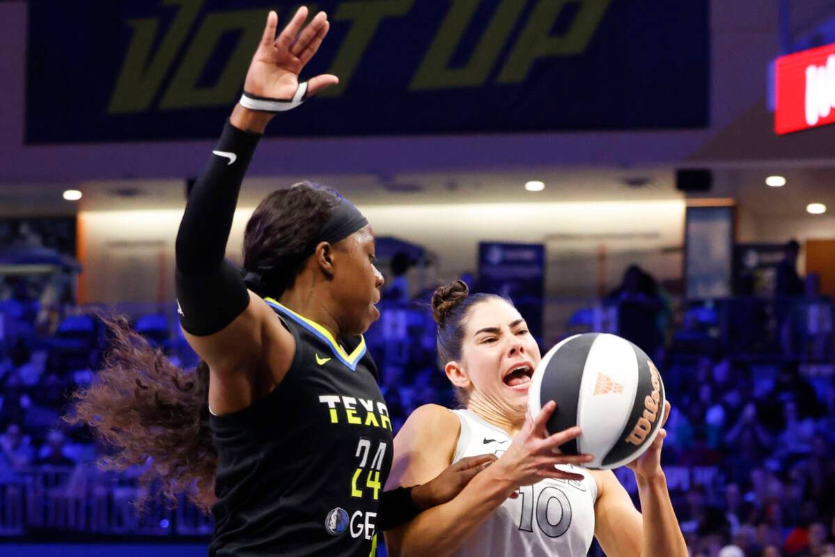 Dallas Wings guard Arike Ogunbowale (left) charges against Las Vegas Aces guard Kelsey Plum dur ...