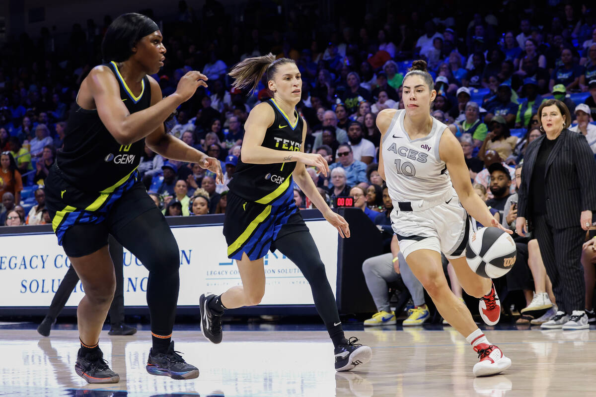 Las Vegas Aces guard Kelsey Plum (10) dribbles past Dallas Wings center Teaira McCowan (left) a ...