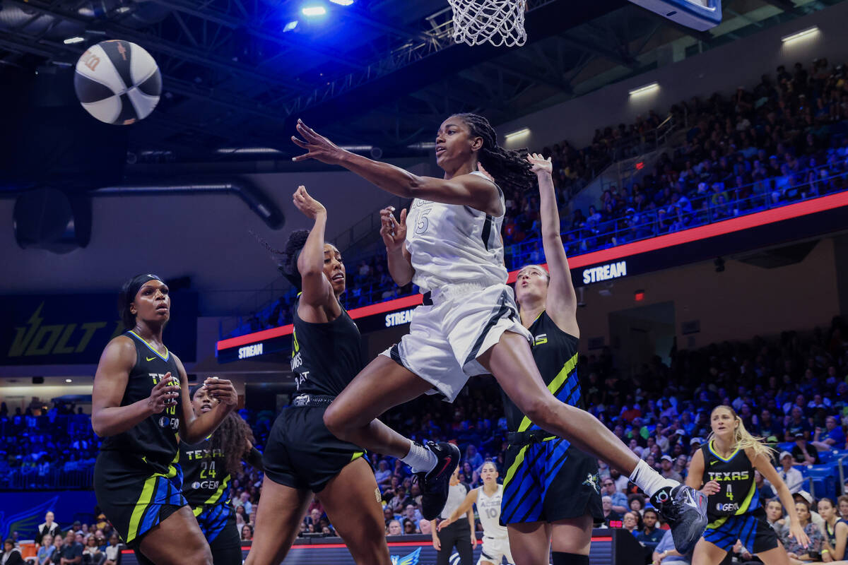 Las Vegas Aces guard Tiffany Hayes (front center) passes over Dallas Wings forward Monique Bill ...