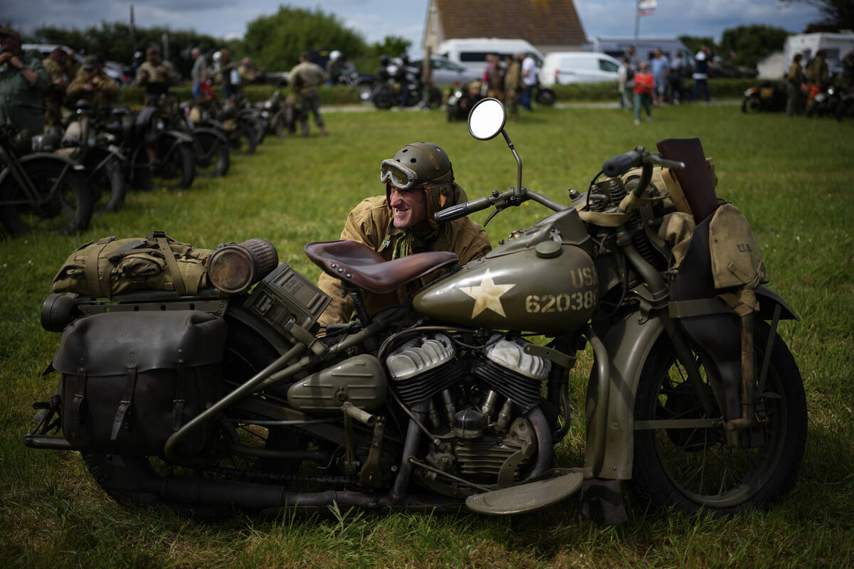 A reenactor performs some maintenance on his US army vintage Harley Davidson motorbike at Utah ...