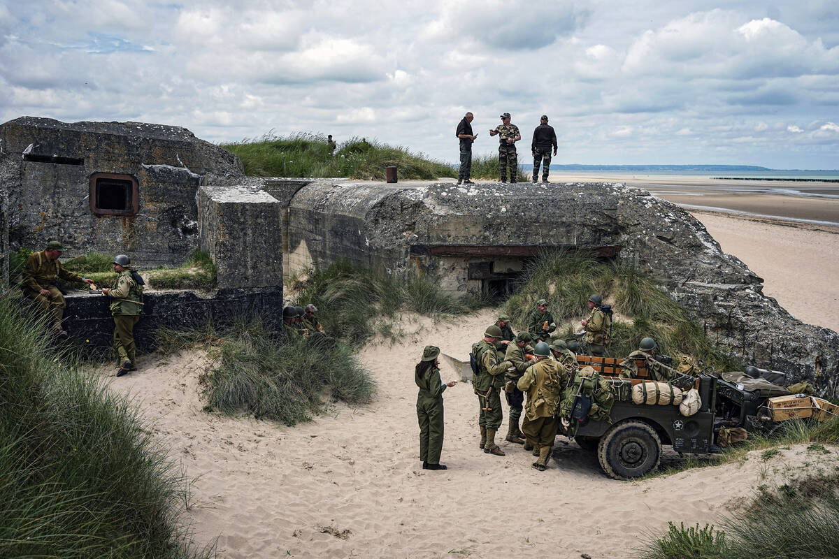 Reenactors have lunch near a bunker during the ceremonies marking the 80th anniversary of D-Day ...