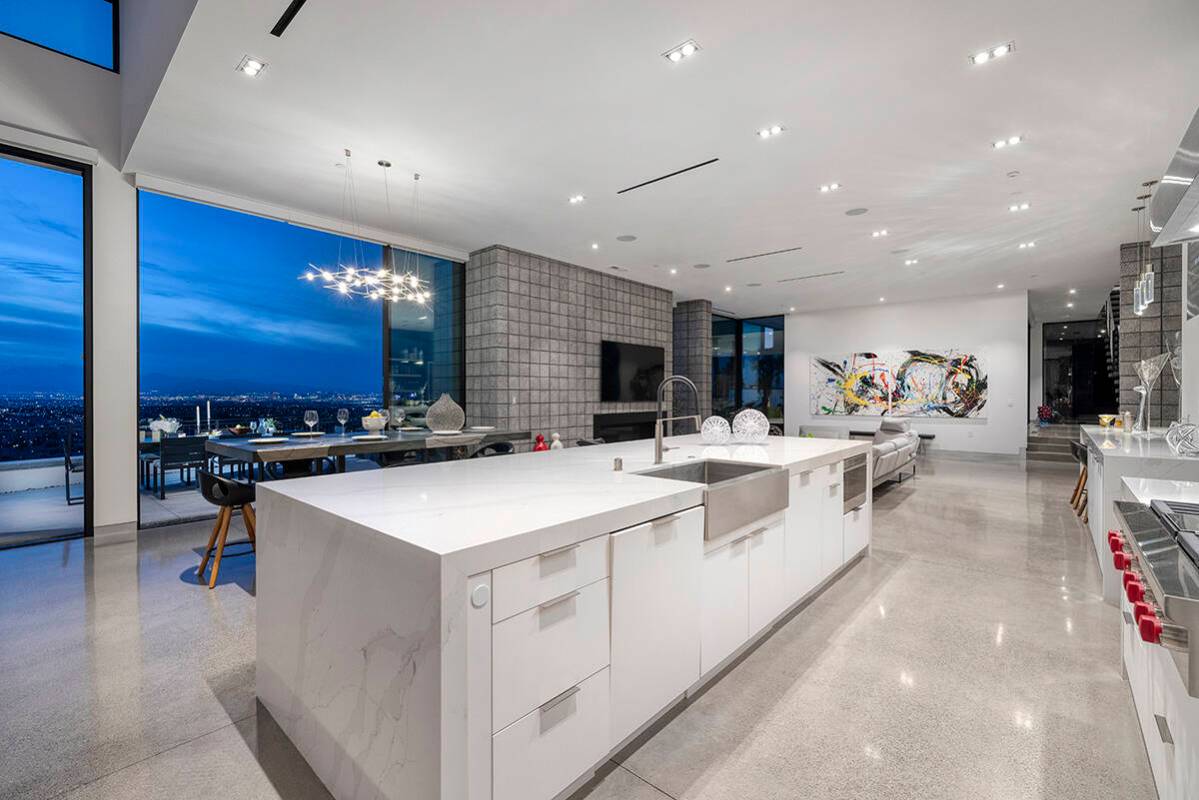 This MacDonald Highlands mansion that sold in May features a modern kitchen with a large centra ...