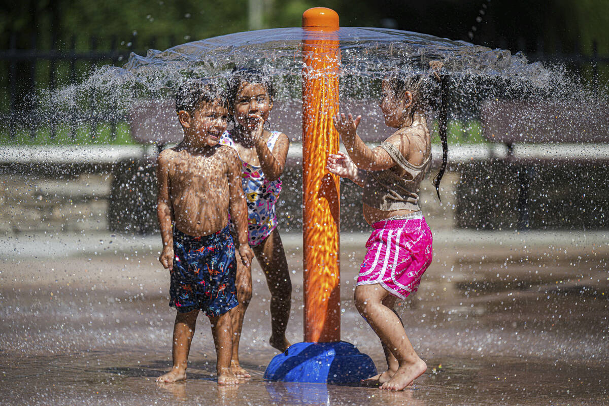 Children play in the splash pad at Monte Vista Park in Chino, Calif. on Tuesday, Aug. 30, 2022. ...