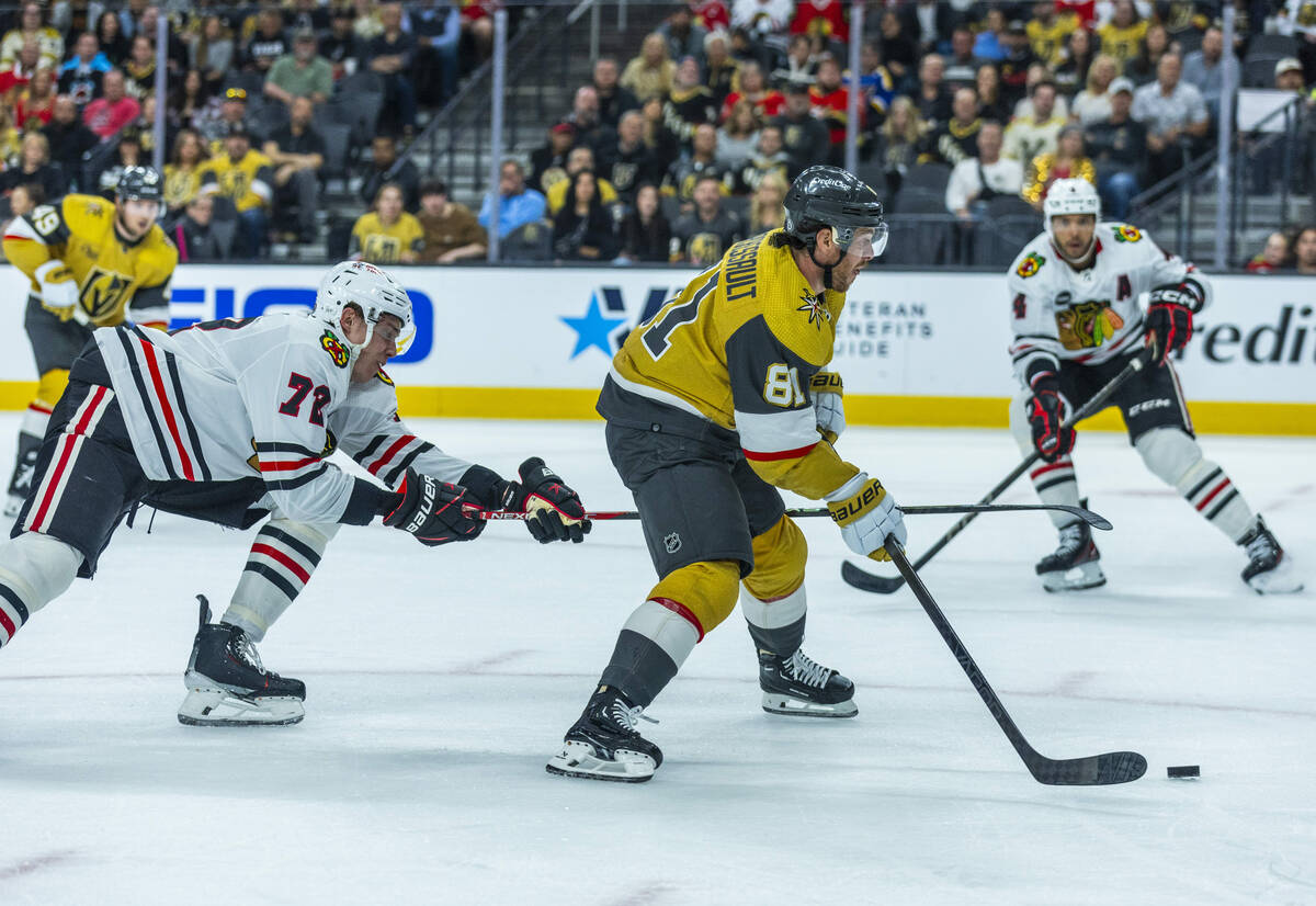 Golden Knights center William Karlsson (71) drives the puck past Chicago Blackhawks defenseman ...