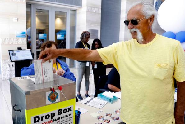 Patrick Jones of Las Vegas casts his ballot at a drop box during early voting at Las Vegas Cit ...