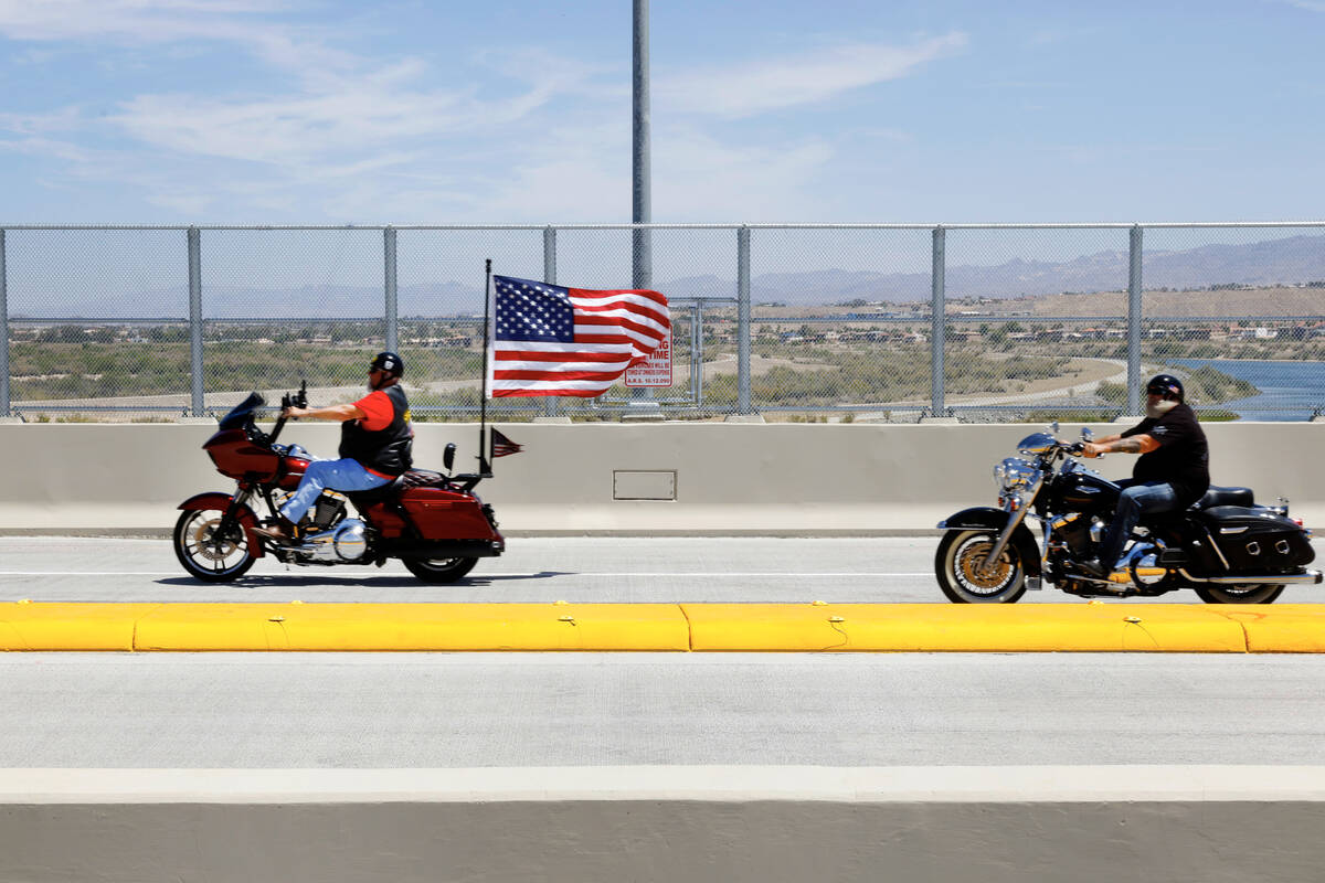 Motorcyclists ride on the newly opened bridge, officially named “Silver Copper Crossing& ...