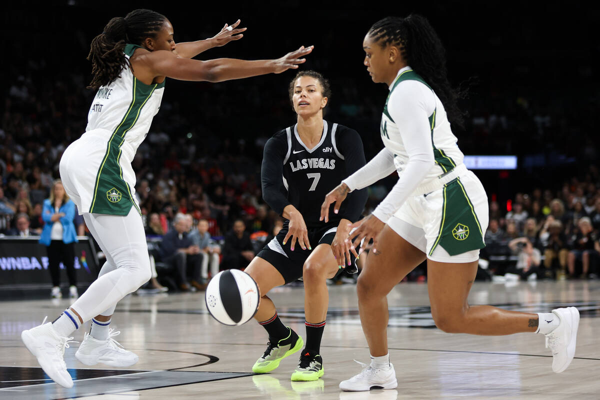 Las Vegas Aces forward Alysha Clark (7) passes the ball between Seattle Storm forward Nneka Ogw ...