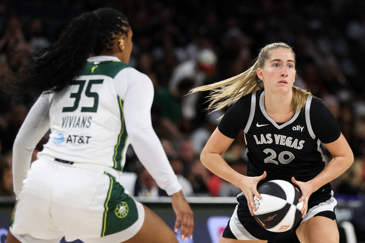 Las Vegas Aces guard Kate Martin (20) looks to pass against Seattle Storm guard Victoria Vivian ...