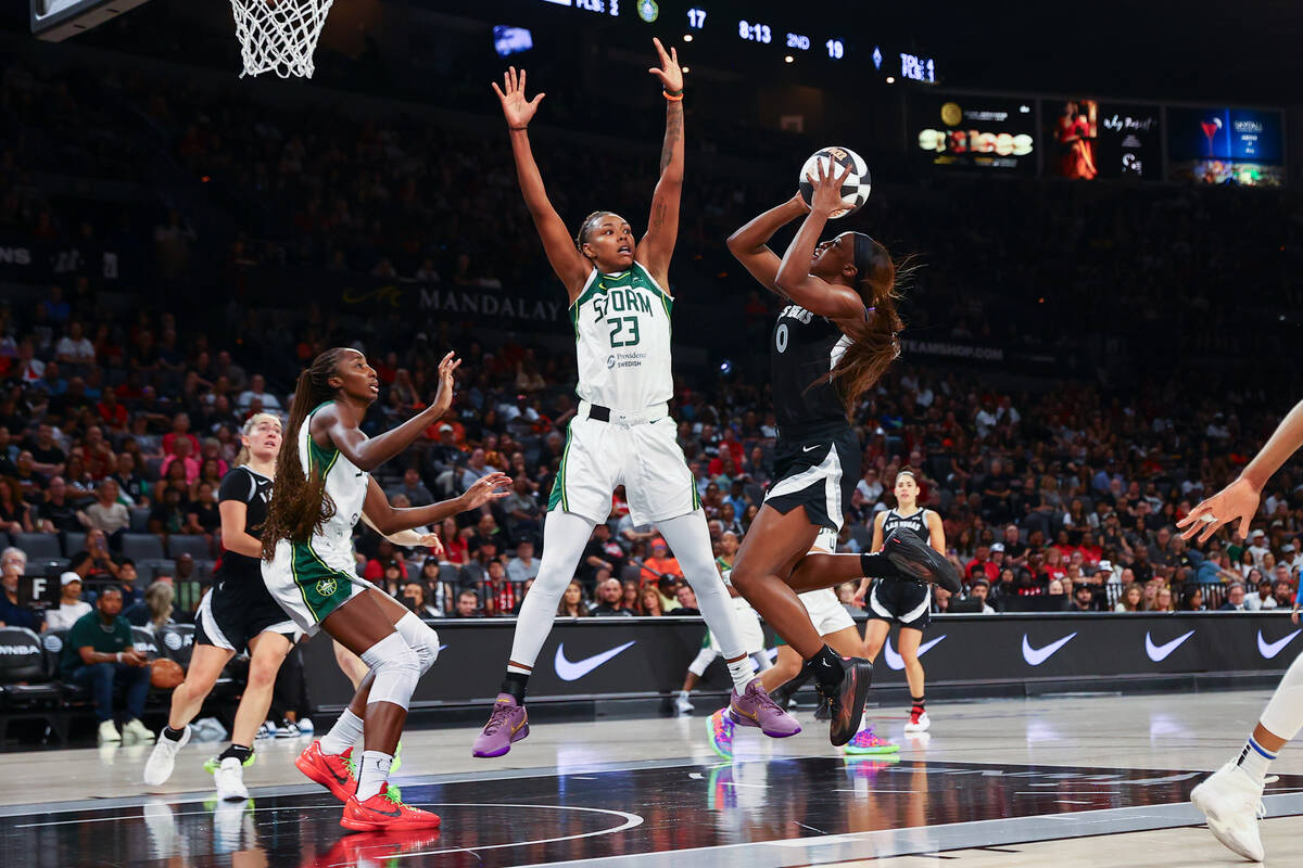 Las Vegas Aces guard Jackie Young (0) shoots against Seattle Storm guard Jordan Horston (23) du ...