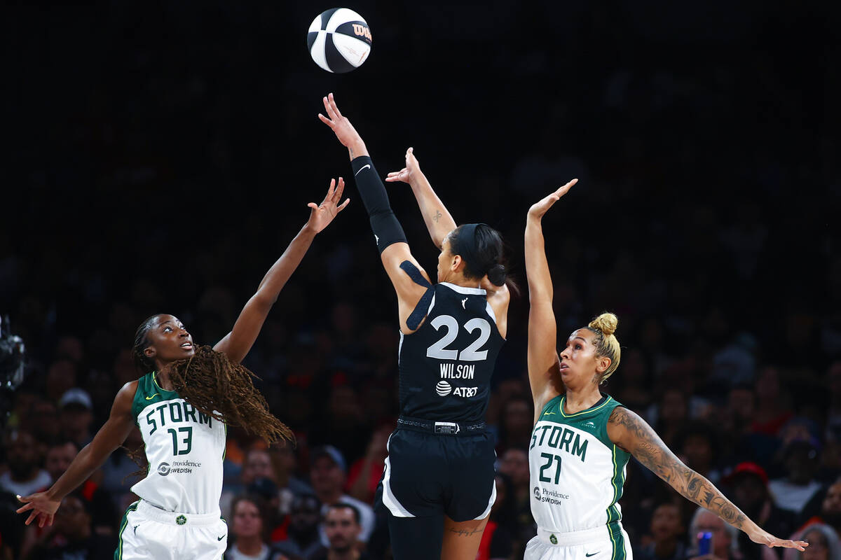 Seattle Storm center Ezi Magbegor (13) and center Mercedes Russell (21) defend while Las Vegas ...