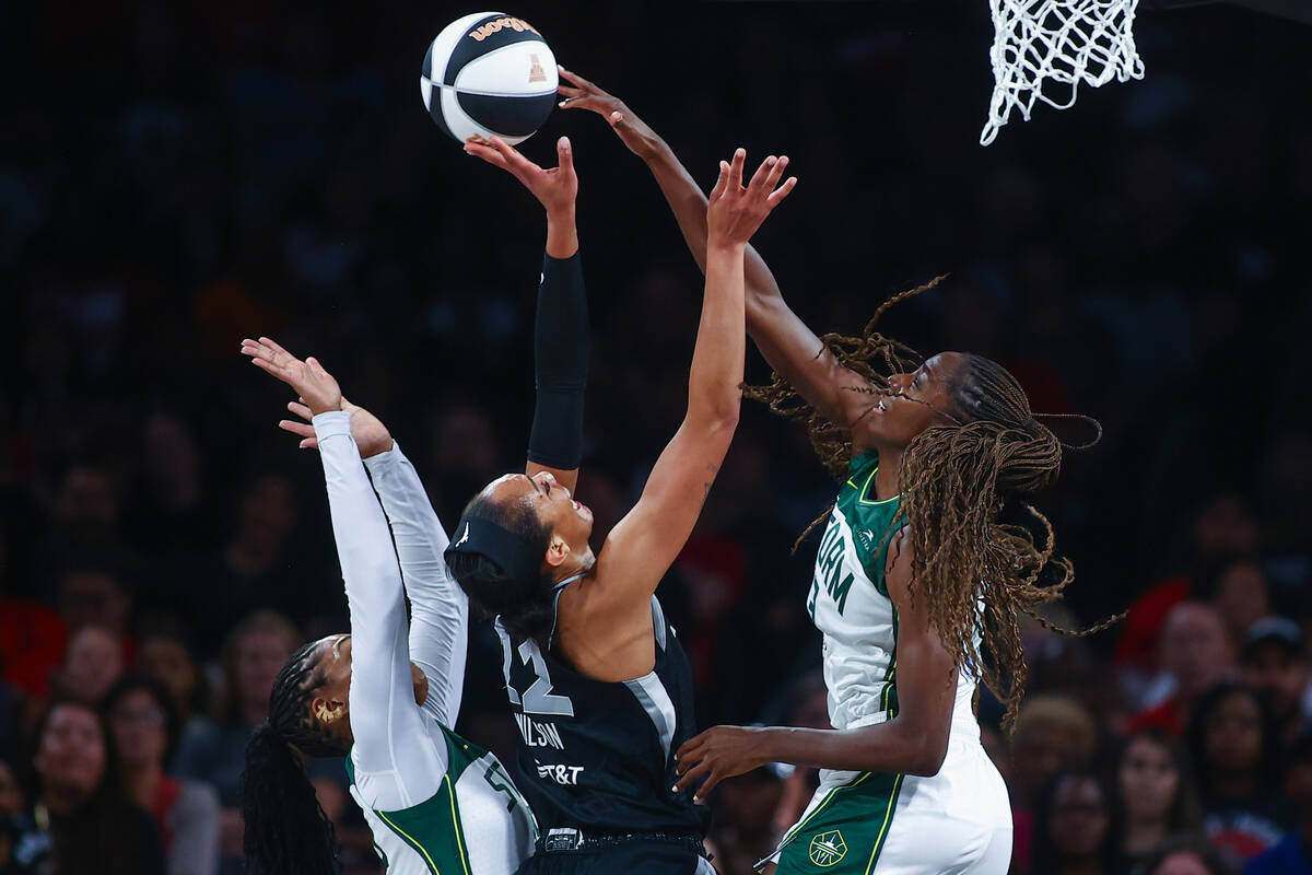 Las Vegas Aces center A'ja Wilson (22) shoots against Seattle Storm guard Victoria Vivians, lef ...