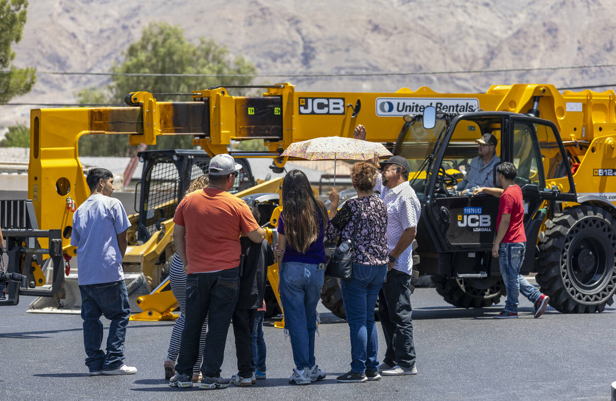 Attendees check out a JCB Loadall in the parking lot during an event at the Southern Nevada Tra ...