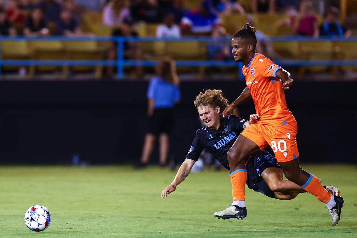 Las Vegas Lights FC midfielder Coleman Gannon falls to the field while Miami FC midfielder Andr ...