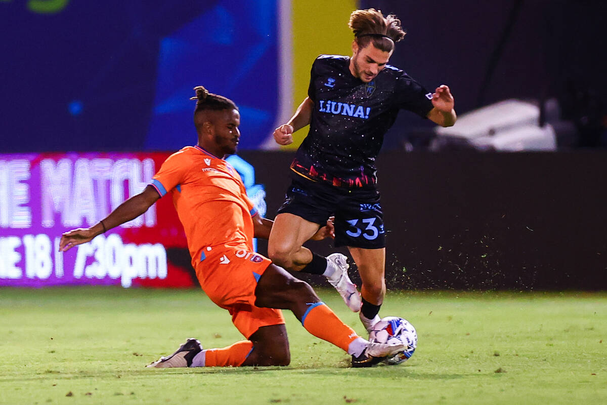 Las Vegas Lights FC defender Gennaro Michael Nigro (33) is slide tackled by Miami FC midfielder ...