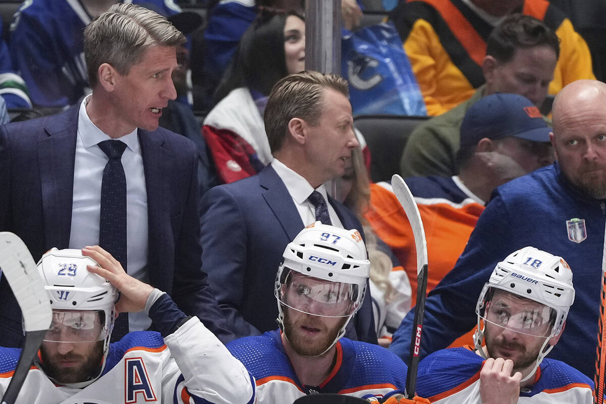 From bottom left to right, Edmonton Oilers' Leon Draisaitl, Connor McDavid and Zach Hyman sit o ...