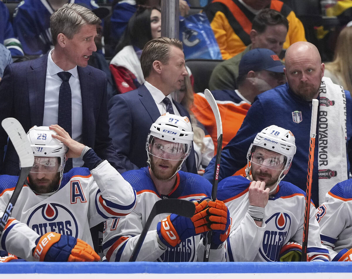 From bottom left to right, Edmonton Oilers' Leon Draisaitl, Connor McDavid and Zach Hyman sit o ...