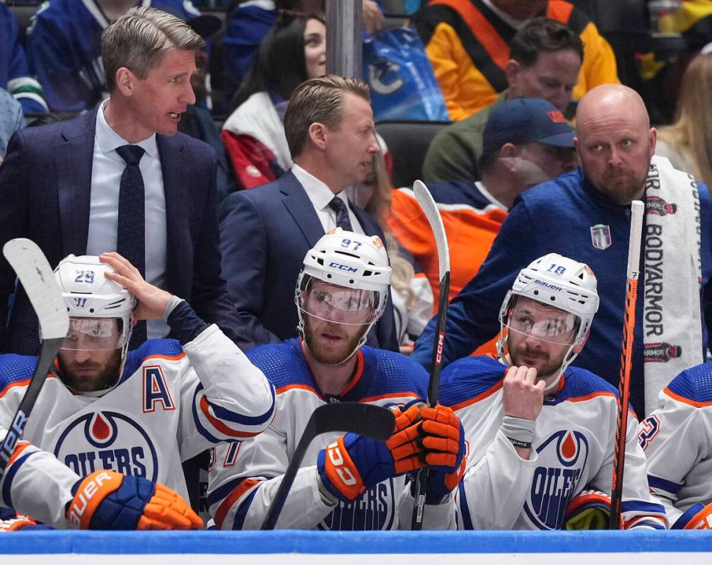 From bottom left to right, Edmonton Oilers' Leon Draisaitl, Connor McDavid and Zach Hyman sit o ...