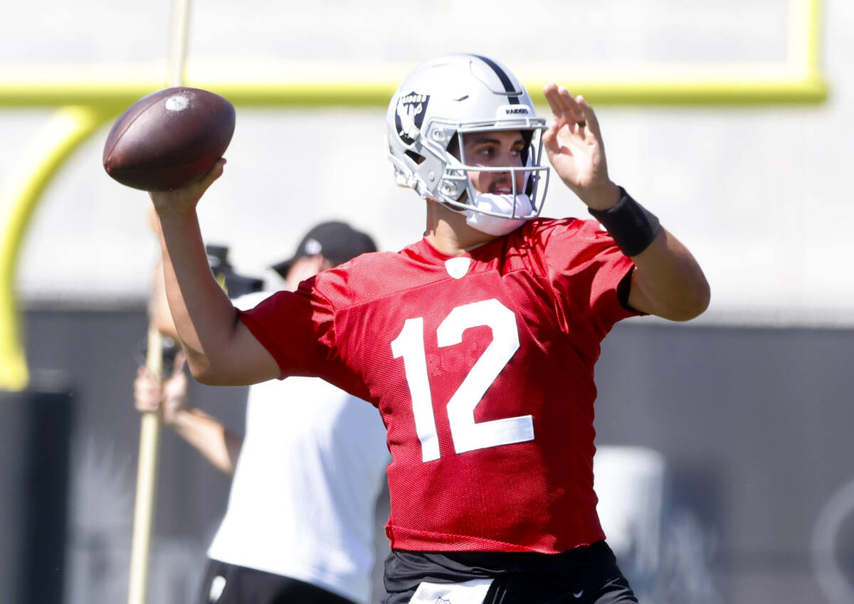 Raiders quarterback Aidan O'Connell (12) prepares to throw the ball during team's practice at t ...