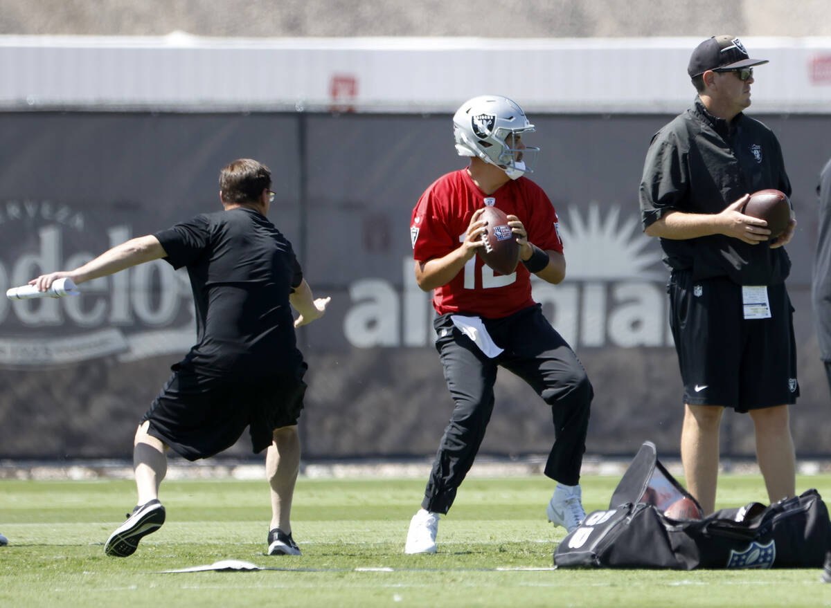 Raiders quarterback Aidan O'Connell (12) prepares to throw the ball during team's practice at t ...