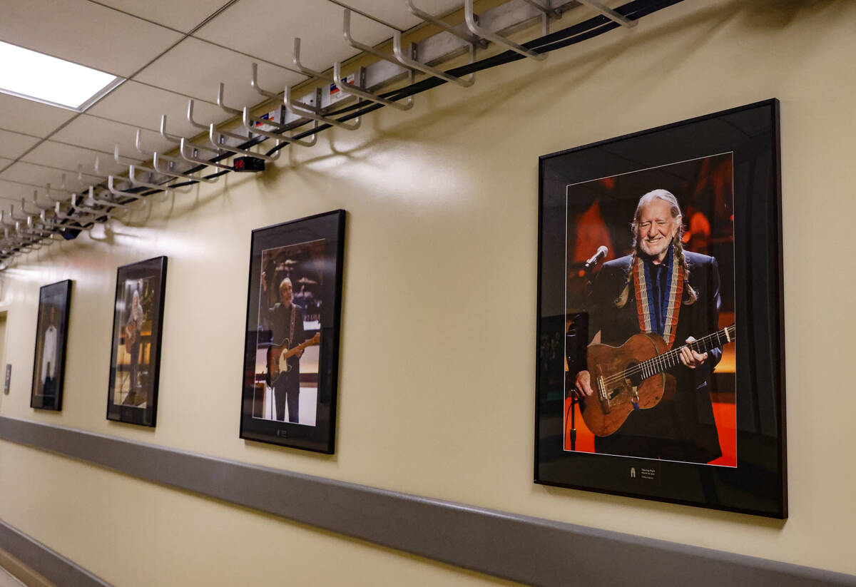 Photos of Willie Nelson and other performers on display in a back hallway at The Smith Center i ...