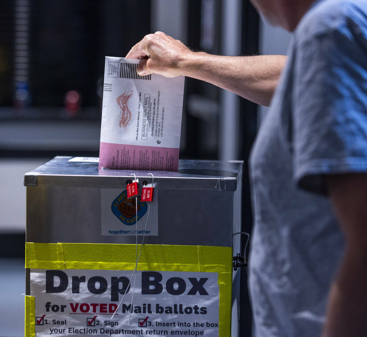 A voter drops off his mail ballot during Nevada's primary election day at the polls within the ...