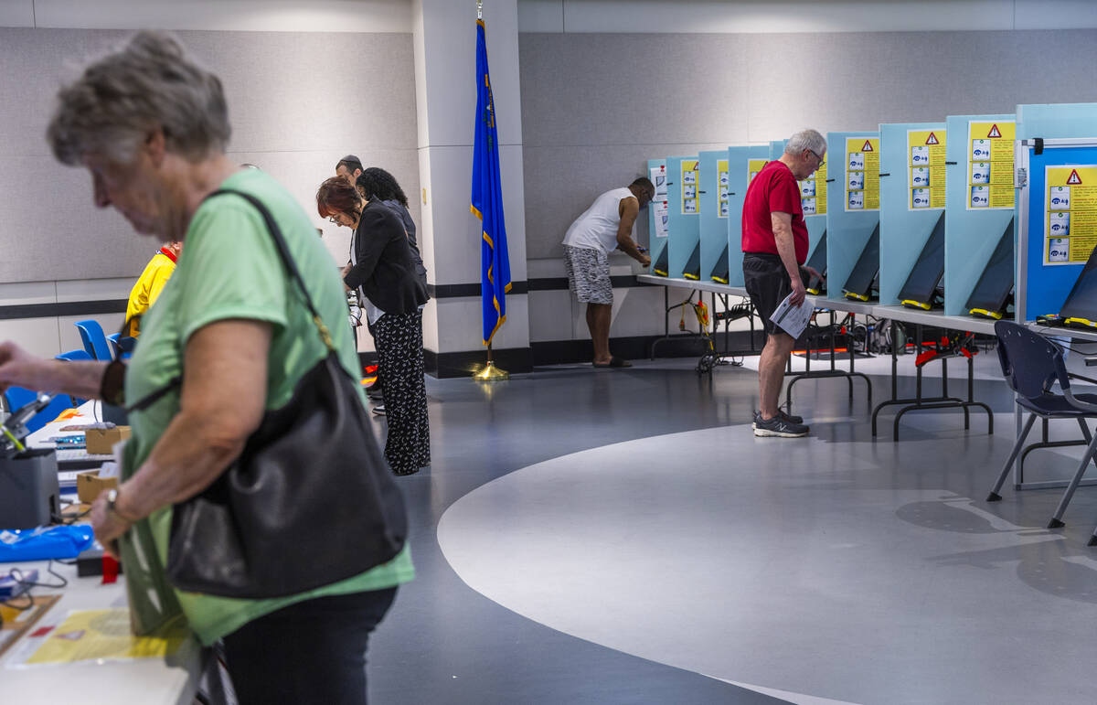 Voters sign in and cast their choices during Nevada's primary election day at the polls within ...