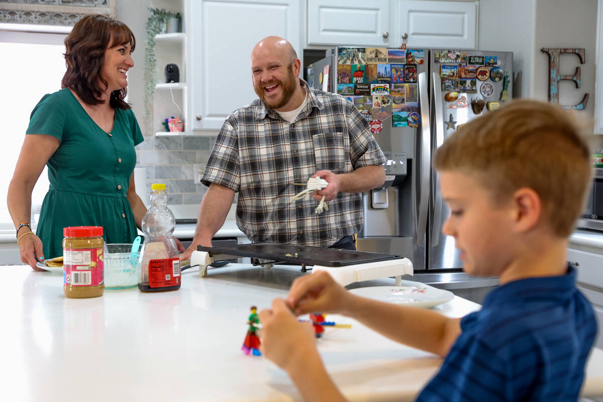 Brandon Eddy, center, laughs with his wife Lisa Eddy and son Mason while making pancakes for di ...