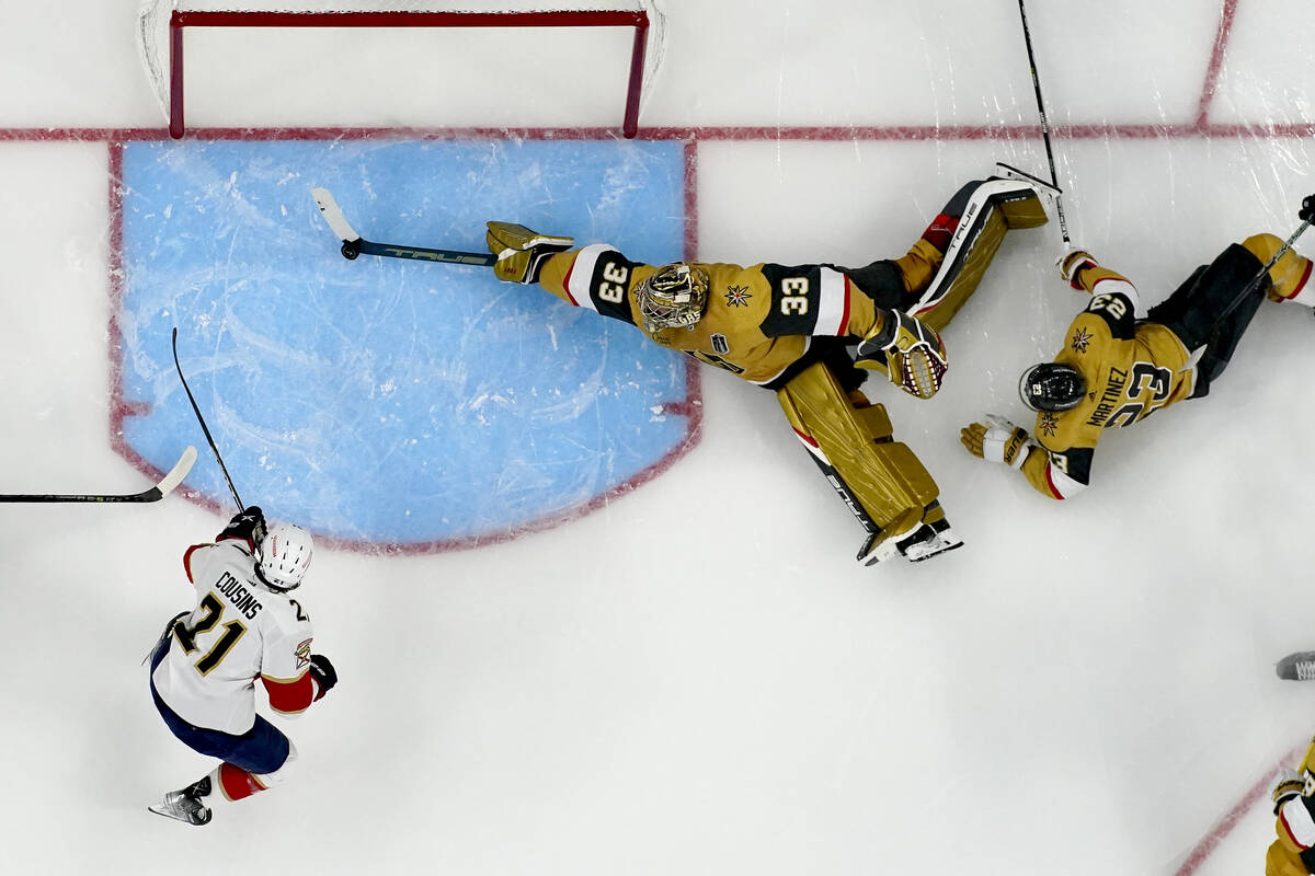 Vegas Golden Knights goaltender Adin Hill (33) blocks a shot on goal by Florida Panthers center ...