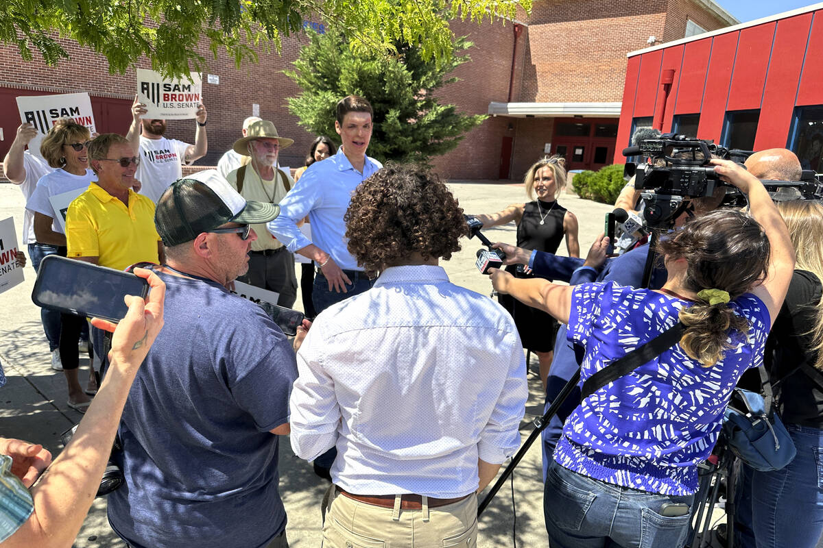 Nevada Senate hopeful Sam Brown speaks to reporters outside Reno High School after casting his ...