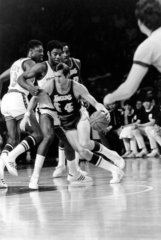 Los Angeles Lakers' Jerry West (44) drives around Milwaukee Bucks' Oscar Robertson and Curtis P ...