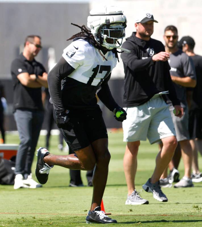 Raiders wide receiver Davante Adams (17) runs drills during an NFL football practice at the Int ...