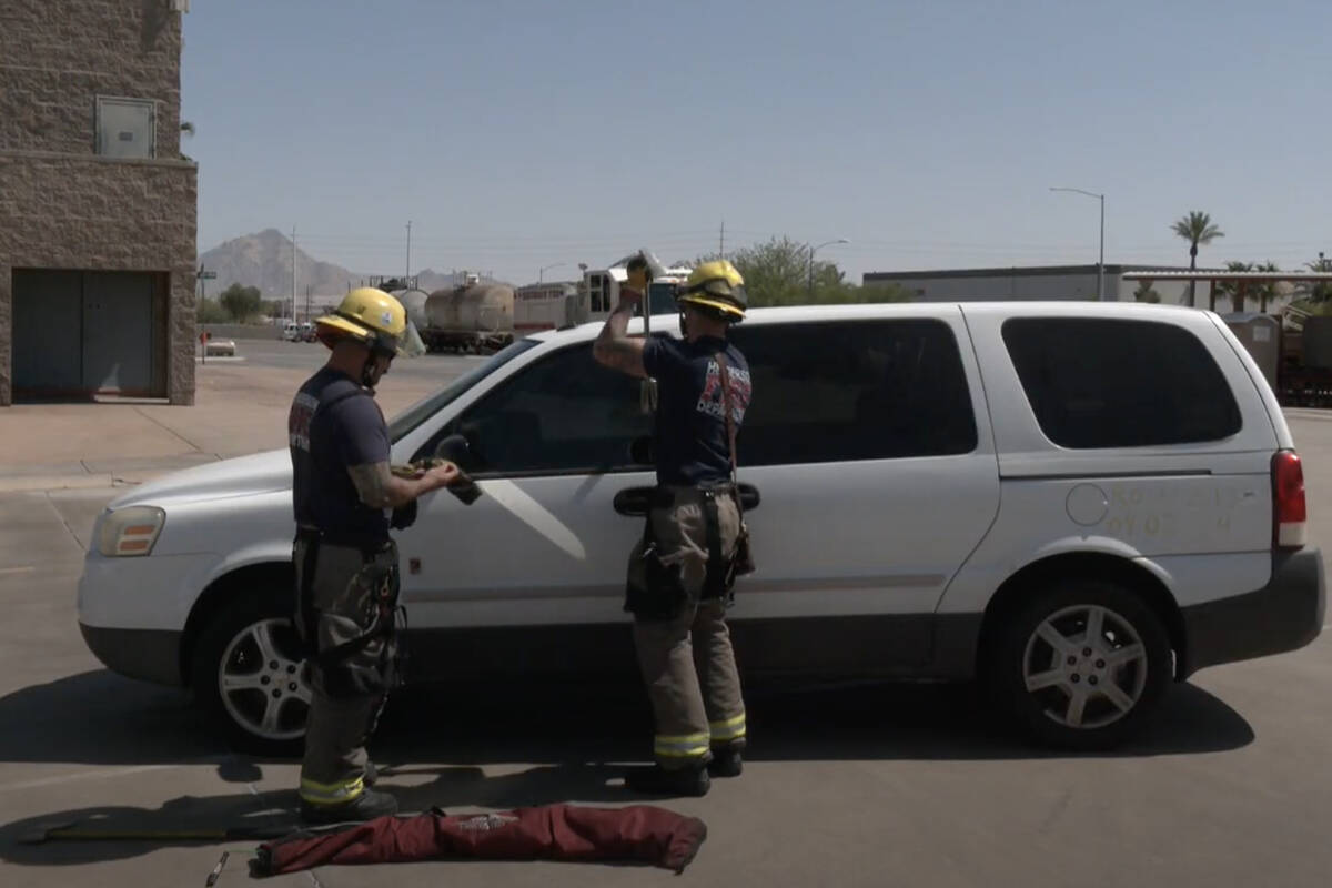 Henderson Fire Department firefighters demonstrate rescuing a child from a hot car during a hea ...