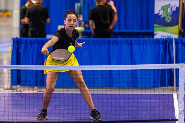 Daniela Filippini returns a serve while playing on one of the temporary courts used to try out ...