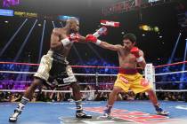 Manny Pacquiao and Floyd Mayweather Jr. trade punches during their welterweight unification box ...